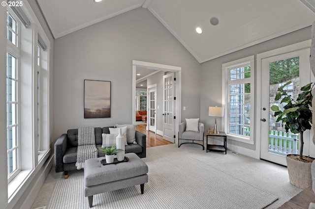 living area featuring carpet floors, high vaulted ceiling, recessed lighting, ornamental molding, and french doors