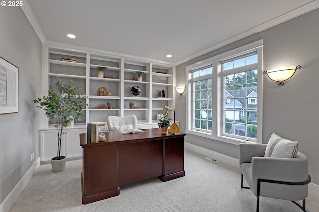 office area featuring light carpet, visible vents, baseboards, and ornamental molding