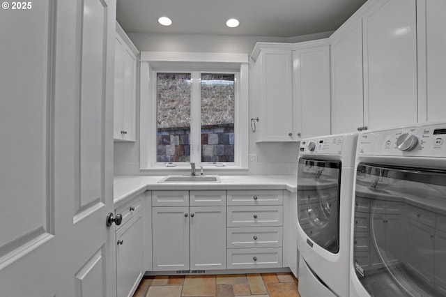 washroom with visible vents, washing machine and dryer, recessed lighting, cabinet space, and a sink