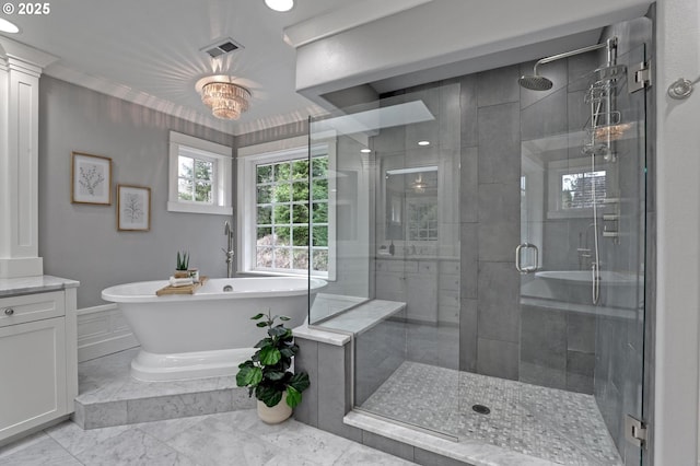 bathroom featuring marble finish floor, a stall shower, a freestanding bath, and vanity