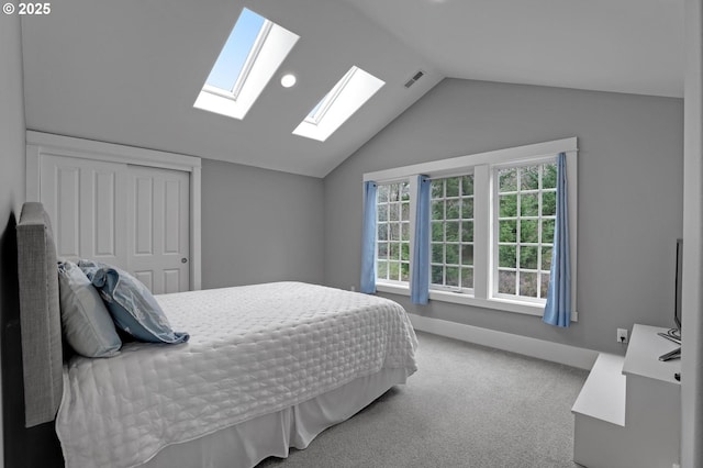 bedroom with visible vents, baseboards, vaulted ceiling, carpet floors, and a closet