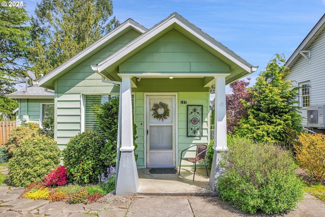 view of front of home featuring ac unit and a porch