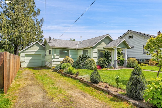 ranch-style house with fence, dirt driveway, and a front lawn