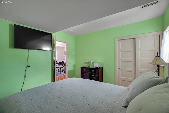 bedroom featuring visible vents and a closet