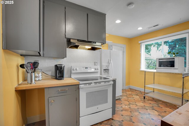 kitchen with gray cabinets, electric stove, tasteful backsplash, under cabinet range hood, and visible vents