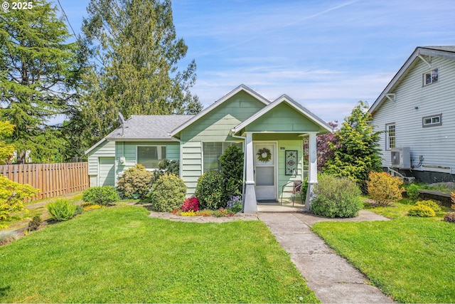 bungalow-style house with covered porch, fence, ac unit, and a front yard