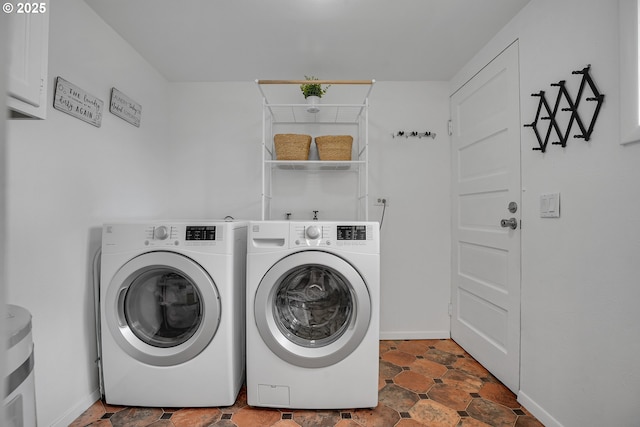 laundry area with separate washer and dryer, laundry area, and baseboards