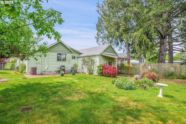 exterior space featuring a fenced backyard and a front lawn