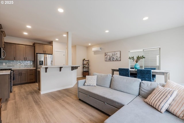 2856 S Nectarine St, Cornelius, OR 97113 - living area with light wood finished floors, recessed lighting, a wall unit AC, and baseboards