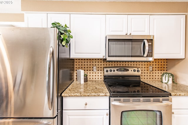 5354 Cody Ave, Eugene, OR 97402 - kitchen featuring stainless steel appliances, backsplash, white cabinetry, and light stone countertops