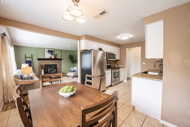 5354 Cody Ave, Eugene, OR 97402 - dining space with light tile patterned floors and a tiled fireplace