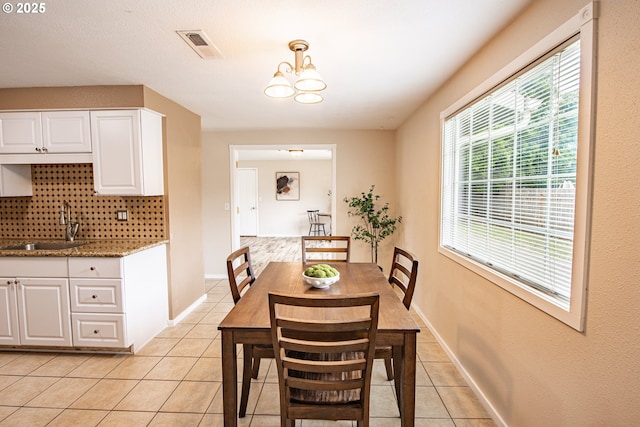 5354 Cody Ave, Eugene, OR 97402 - dining space with light tile patterned floors, a chandelier, and wet bar