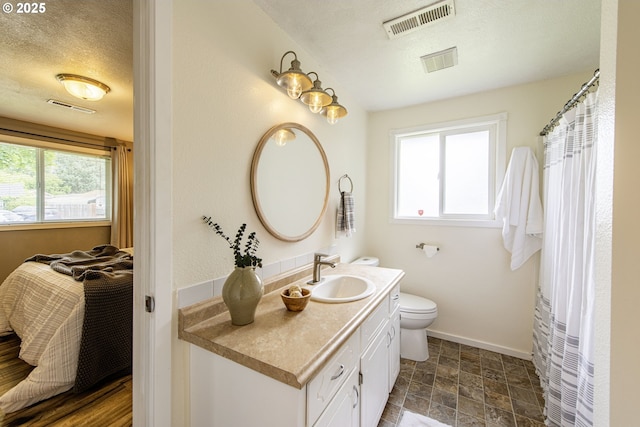 5354 Cody Ave, Eugene, OR 97402 - bathroom with vanity, a textured ceiling, and stone finish floors