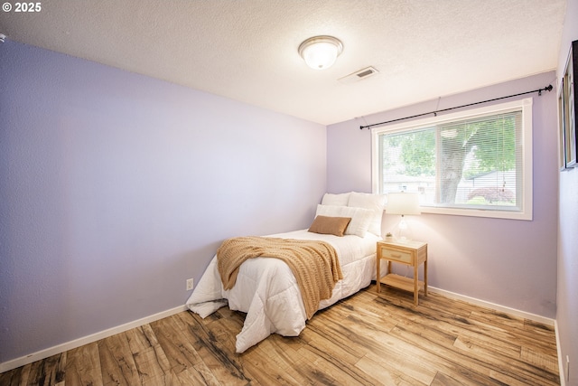 5354 Cody Ave, Eugene, OR 97402 - bedroom featuring wood finished floors and a textured ceiling