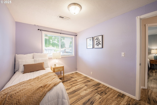 5354 Cody Ave, Eugene, OR 97402 - bedroom featuring wood finished floors and a textured ceiling