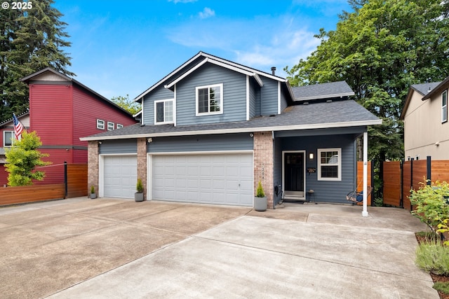 view of front of house with fence, concrete driveway, a shingled roof, and an attached garage