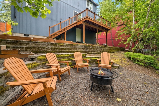 view of patio / terrace with a fire pit, stairway, and a wooden deck