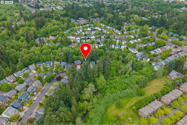 aerial view of property and surrounding area with nearby suburban area