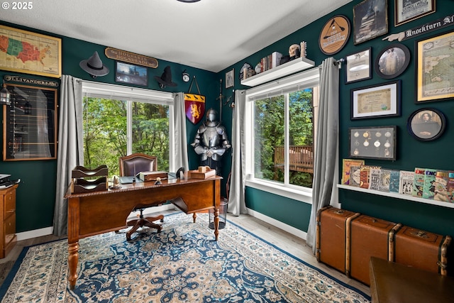 office area with baseboards and plenty of natural light