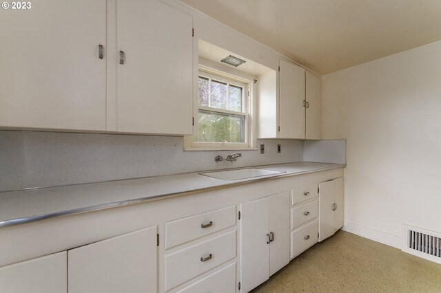 3148 Willamette St, Eugene, OR 97405 - kitchen with a sink, light countertops, decorative backsplash, and white cabinets