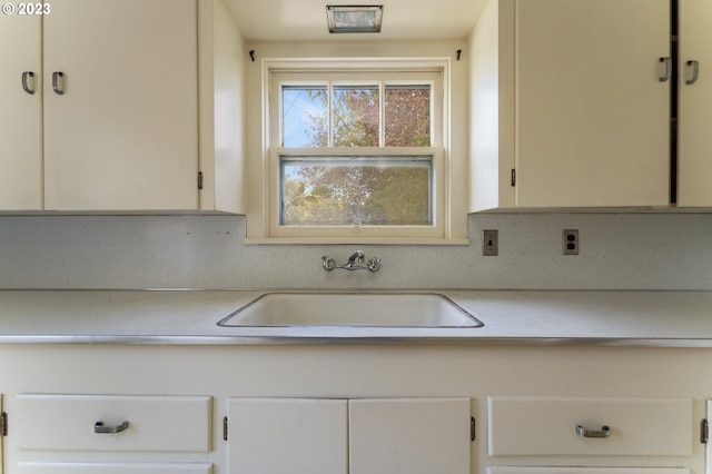 3148 Willamette St, Eugene, OR 97405 - kitchen featuring a sink, light countertops, and white cabinets