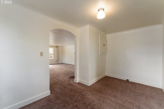 3148 Willamette St, Eugene, OR 97405 - carpeted spare room featuring arched walkways, electric panel, and baseboards