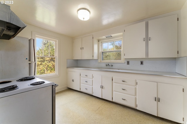 3148 Willamette St, Eugene, OR 97405 - kitchen featuring range hood, white range with electric cooktop, a sink, and plenty of natural light