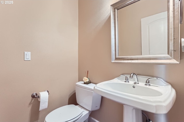 bathroom with toilet and a sink