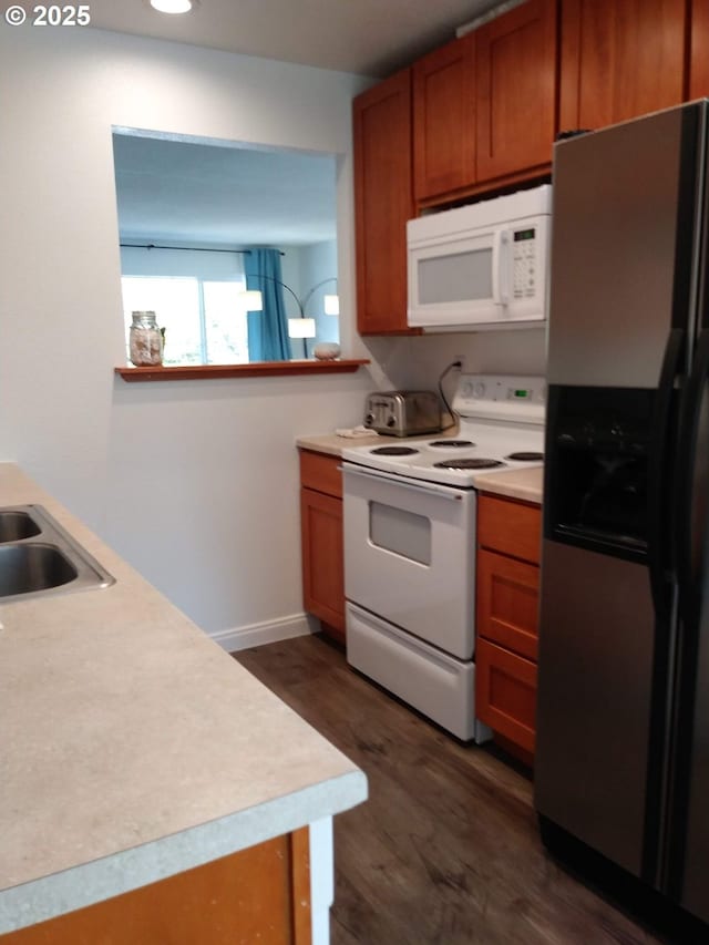 878 I St, Washougal, WA 98671 - kitchen featuring white appliances, brown cabinets, light countertops, and dark wood finished floors