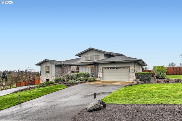 view of front of house with a front yard and a garage