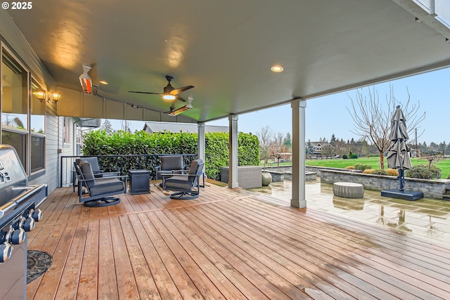 wooden deck with ceiling fan and an outdoor hangout area