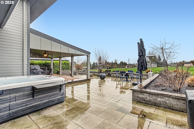 view of patio / terrace with a grill and a hot tub