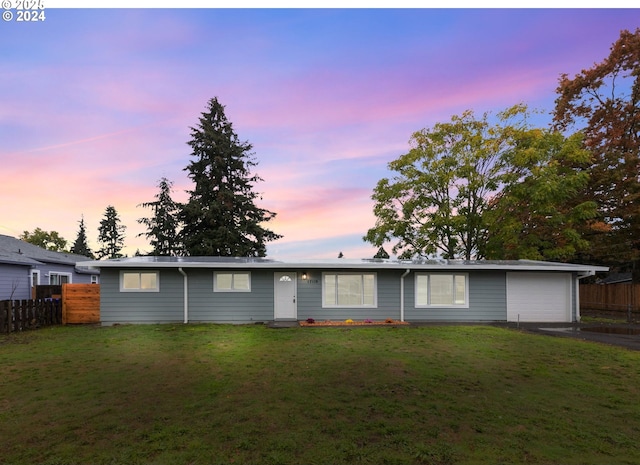 ranch-style home featuring a yard