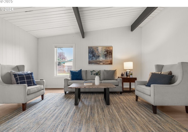 living room with hardwood / wood-style floors and vaulted ceiling with beams