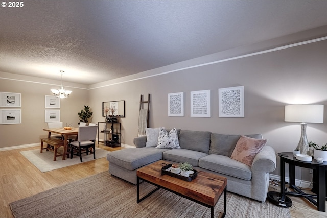 living room featuring hardwood / wood-style floors, a notable chandelier, and a textured ceiling