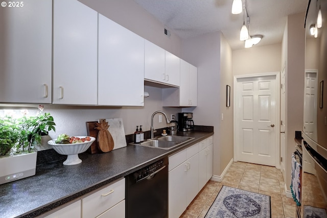 kitchen featuring sink, a textured ceiling, light tile patterned floors, dishwasher, and white cabinets