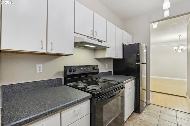 kitchen featuring light tile patterned flooring, under cabinet range hood, white cabinets, black appliances, and dark countertops