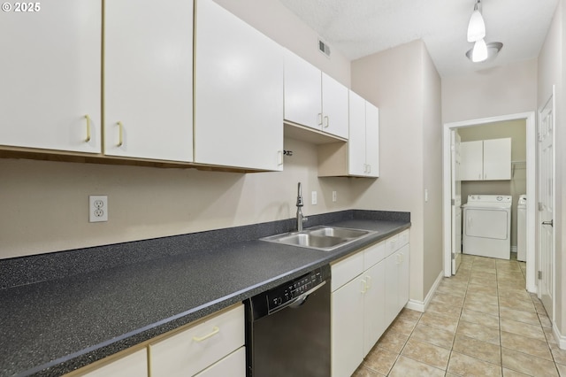 kitchen with a sink, visible vents, white cabinets, black dishwasher, and washing machine and clothes dryer