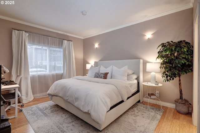 bedroom featuring ornamental molding and light hardwood / wood-style flooring