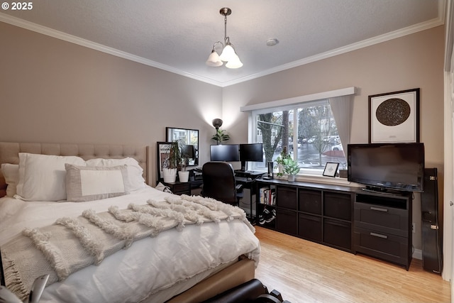 bedroom featuring crown molding, light hardwood / wood-style floors, and a chandelier