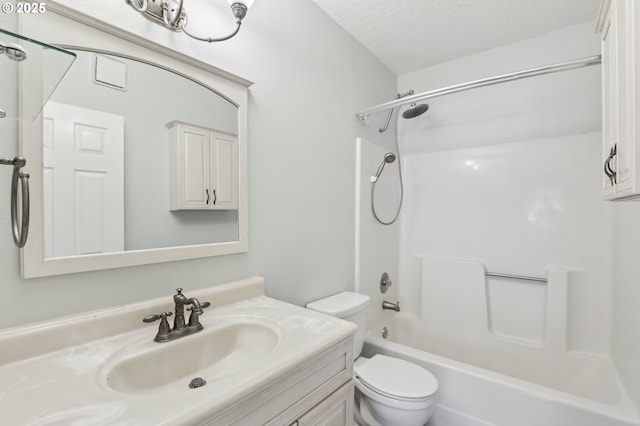 full bathroom with  shower combination, a textured ceiling, toilet, and vanity