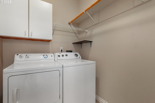 laundry room featuring cabinets and washer and dryer