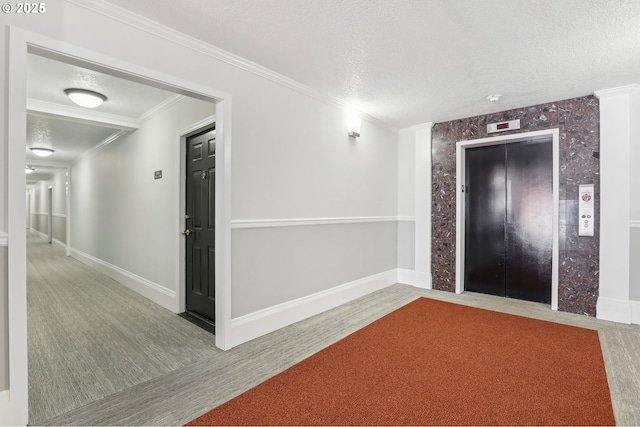 hall featuring elevator, crown molding, a textured ceiling, and baseboards