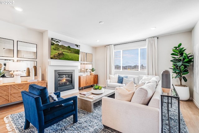 883 Legacy St, Eugene, OR 97402 - living area with wood finished floors, recessed lighting, a glass covered fireplace, and baseboards