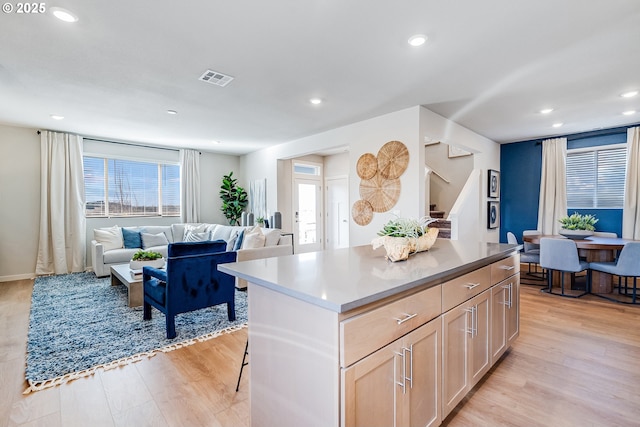 883 Legacy St, Eugene, OR 97402 - kitchen with a center island, light wood-style flooring, recessed lighting, open floor plan, and light brown cabinetry