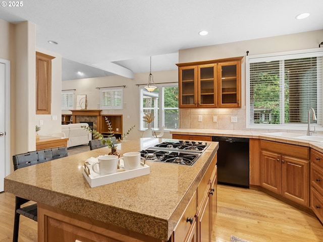 17712 SW 81st Pl, Durham, OR 97224 - kitchen with black dishwasher, a sink, light wood finished floors, glass insert cabinets, and recessed lighting