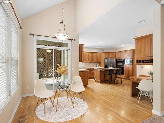 17712 SW 81st Pl, Durham, OR 97224 - dining space with healthy amount of natural light, light wood-style flooring, baseboards, lofted ceiling, and recessed lighting