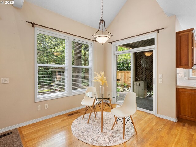 17712 SW 81st Pl, Durham, OR 97224 - dining space featuring baseboards, light wood-style floors, and vaulted ceiling