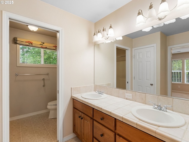 17712 SW 81st Pl, Durham, OR 97224 - full bath featuring double vanity, toilet, baseboards, and tile patterned floors