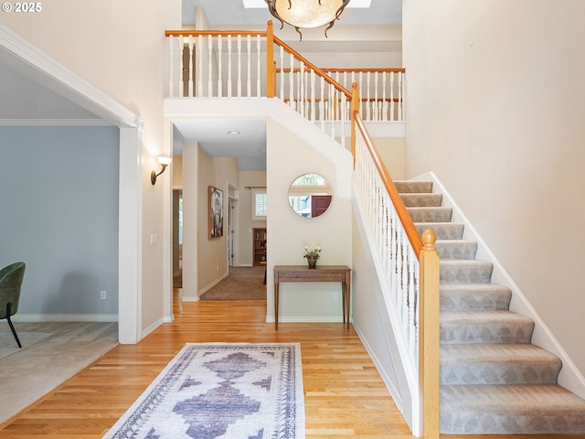 17712 SW 81st Pl, Durham, OR 97224 - stairway featuring a towering ceiling, wood finished floors, and baseboards